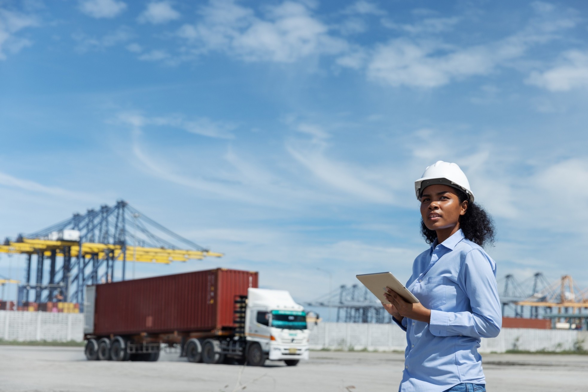 a-female-logistics-officer-in-a-hard-hat-observes-2025-07-06-18-03-51-utc (1) (1) (1) (1)