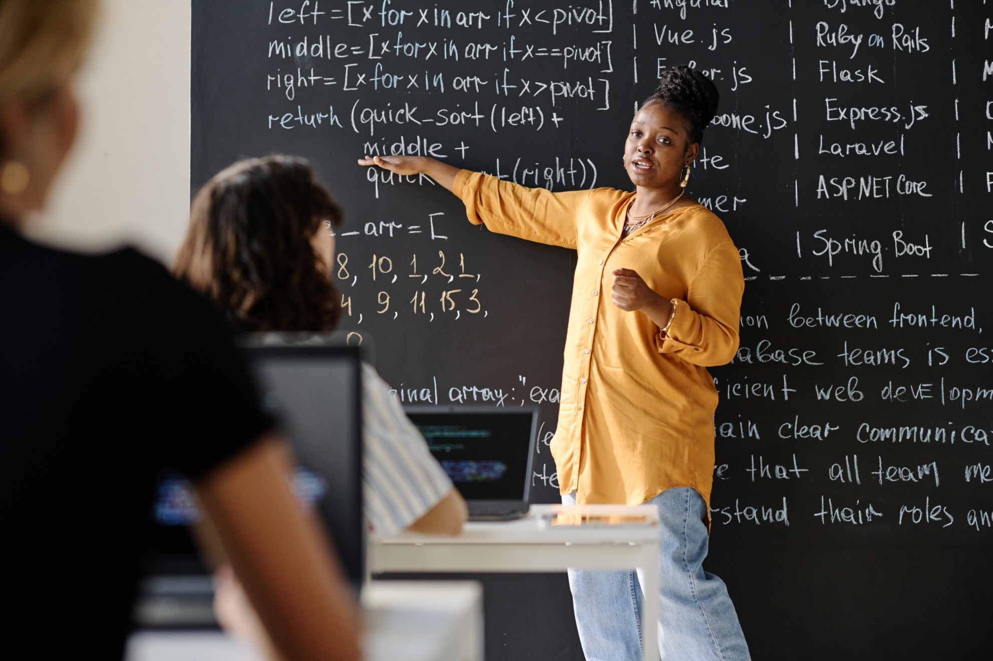 teacher-explaining-material-to-students-at-class